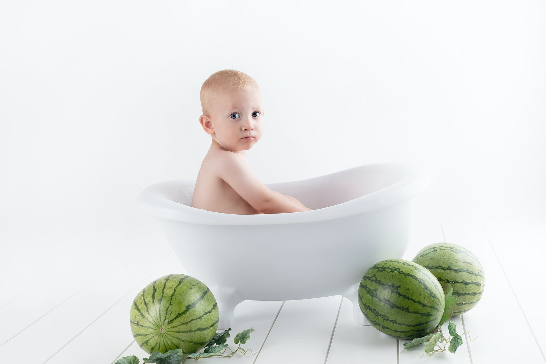 photography of baby on bathtub
