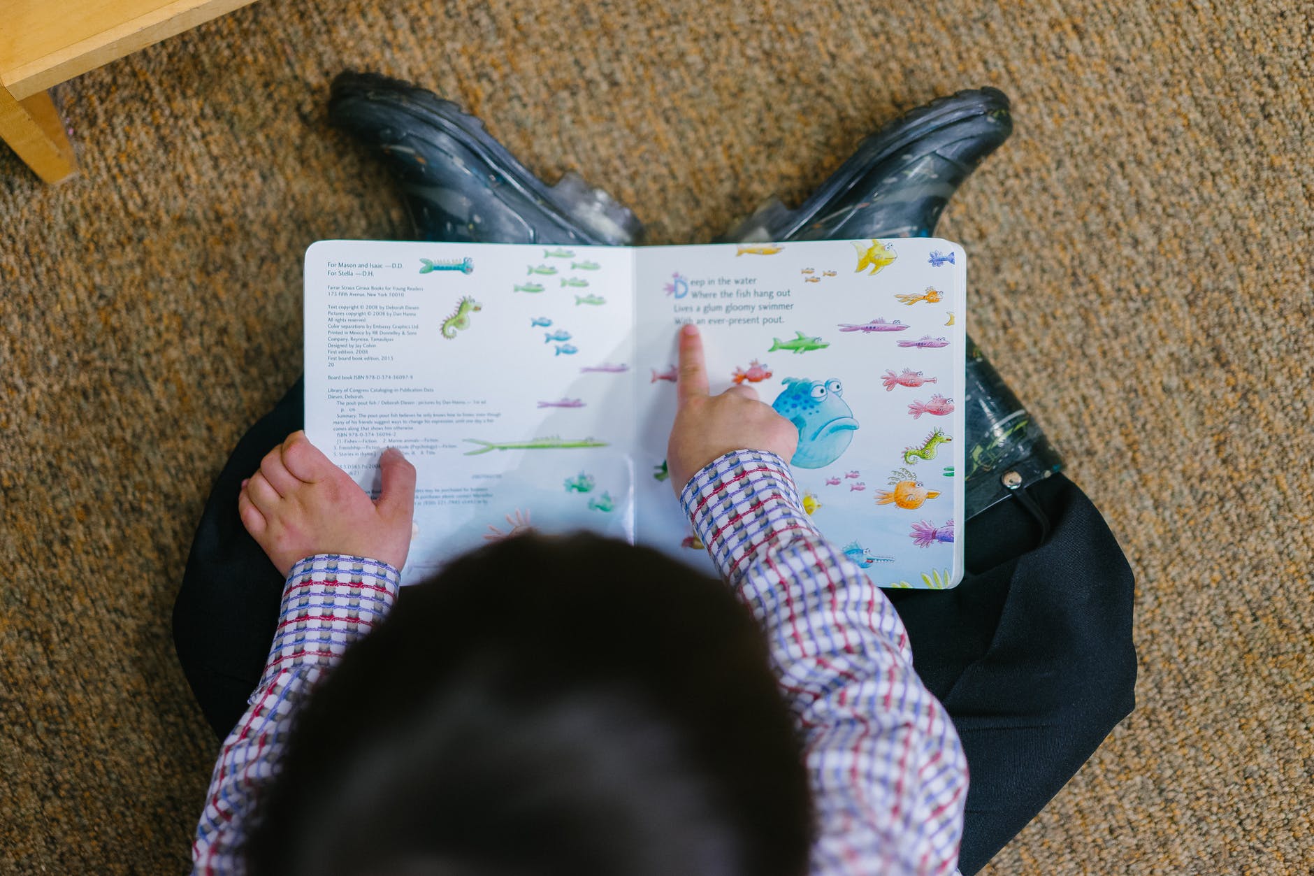 photo of a boy reading book